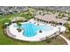 Resort-style community pool with spacious deck, lounge chairs and beautiful landscaping at 9907 Spanish Lime Ct, Riverview, FL 33578