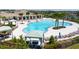 Resort-style community pool featuring palm trees, sun loungers, shaded cabanas and ample seating at 9907 Spanish Lime Ct, Riverview, FL 33578