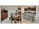Open dining room area with a table and view of the kitchen with barstool seating at 9907 Spanish Lime Ct, Riverview, FL 33578