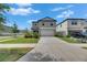 Attractive two-story home featuring a well-maintained lawn, concrete driveway, and lush landscaping at 9907 Spanish Lime Ct, Riverview, FL 33578