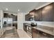 Close up of kitchen featuring dark cabinets, stainless steel appliances, and granite countertops at 9907 Spanish Lime Ct, Riverview, FL 33578