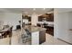 Open kitchen with island, dark cabinets, stainless steel appliances, and granite countertops at 9907 Spanish Lime Ct, Riverview, FL 33578