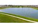 Scenic view of a neighborhood lake with walking path surrounded by lush greenery at 9907 Spanish Lime Ct, Riverview, FL 33578