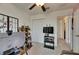 Bright office area featuring a ceiling fan, shelving for storage, and a TV at 9907 Spanish Lime Ct, Riverview, FL 33578