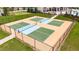 Aerial view of community pickleball courts with green and blue playing surfaces, and black chain-link fencing at 9907 Spanish Lime Ct, Riverview, FL 33578