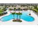 Community pool boasts mature palms, pristine waters, and ample lounging space at 9907 Spanish Lime Ct, Riverview, FL 33578