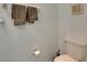 Compact powder room featuring a standard toilet, towel rack, and toilet paper holder at 9907 Spanish Lime Ct, Riverview, FL 33578