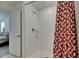 Bright shower with white tile walls and a decorative shower curtain at 9907 Spanish Lime Ct, Riverview, FL 33578