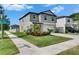 Picturesque two-story home on a corner lot with vibrant landscaping, a spacious driveway, and clear street signage at 9907 Spanish Lime Ct, Riverview, FL 33578