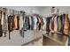 Spacious walk-in closet featuring ample storage space, hanging racks, and shelving at 9907 Spanish Lime Ct, Riverview, FL 33578