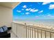Breathtaking ocean view from the condo balcony with comfortable outdoor seating and white railings at 9980 Gulf Blvd # 603, Treasure Island, FL 33706
