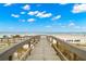 Easy access to the pristine beach from a wooden boardwalk for a relaxing day by the sea at 9980 Gulf Blvd # 603, Treasure Island, FL 33706