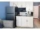 Modern kitchenette featuring stainless steel appliances, white cabinets, and convenient amenities for easy meal preparation at 9980 Gulf Blvd # 603, Treasure Island, FL 33706