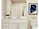 Clean bathroom featuring a white vanity with ample storage, a toilet, and modern decor at 10282 Purple Leaf Ct, Riverview, FL 33578