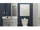 Stylish bathroom with white fixtures, blue walls, and minimalist decor at 10282 Purple Leaf Ct, Riverview, FL 33578