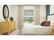 Bright bedroom featuring a large window, wooden accents, and a serene atmosphere at 10282 Purple Leaf Ct, Riverview, FL 33578