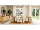 Elegant dining room featuring a wooden table, white chairs, and plenty of natural light at 10282 Purple Leaf Ct, Riverview, FL 33578