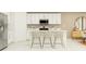 Modern kitchen featuring white cabinetry, a stainless steel microwave, and a center island with bar seating at 10282 Purple Leaf Ct, Riverview, FL 33578