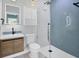 This renovated bathroom includes a step-in shower with blue tile, plus modern fixtures at 1045 22Nd N Ave, St Petersburg, FL 33704