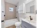 Updated bathroom features decorative tile accent wall and modern fixtures at 1045 22Nd N Ave, St Petersburg, FL 33704
