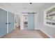 Bright bedroom with a trendy sliding barn door and a glimpse into the ensuite bathroom at 1045 22Nd N Ave, St Petersburg, FL 33704