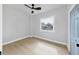 Bright bedroom with wood-look floors, large window, and ceiling fan at 1045 22Nd N Ave, St Petersburg, FL 33704