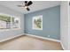 Bright bedroom with fresh paint, two windows, ceiling fan, and wood-look floors at 1045 22Nd N Ave, St Petersburg, FL 33704