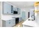 Bright kitchen with stainless steel appliances, blue cabinetry, and quartz countertops at 1045 22Nd N Ave, St Petersburg, FL 33704