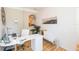 Bright home office with white desk, stylish chair, and ample natural light at 10473 Villa View Cir, Tampa, FL 33647