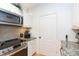 Modern kitchen features granite countertops, stainless steel appliances, and white cabinetry at 10473 Villa View Cir, Tampa, FL 33647