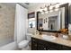 Bathroom with single sink vanity, tile flooring, and shower-tub combo with framed mirror at 1133 Split Silk St, Valrico, FL 33594