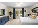 Primary bedroom with blue dresser, white bedding, ceiling fan, and natural light from a large window at 1133 Split Silk St, Valrico, FL 33594