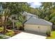 Two story home featuring a three car garage, lush landscaping, and a manicured lawn at 1133 Split Silk St, Valrico, FL 33594