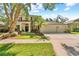 Charming two story home with three car garage, a well-manicured lawn and tropical landscaping at 1133 Split Silk St, Valrico, FL 33594