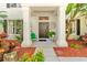 Inviting front porch features stately white columns, a decorative front door, and lush landscaping at 1133 Split Silk St, Valrico, FL 33594