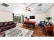 Entertainment room with a pool table, comfortable leather seating, and sliding doors leading to the backyard at 1133 Split Silk St, Valrico, FL 33594