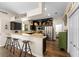 Modern kitchen with granite countertops, stainless steel appliances, dark cabinetry, and convenient breakfast bar seating at 1133 Split Silk St, Valrico, FL 33594