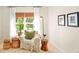 Cozy living room area with chair, woven accessories, and natural light from a large window at 1133 Split Silk St, Valrico, FL 33594