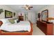 Comfortable main bedroom with a large bed, classic furniture, and ample natural light at 1133 Split Silk St, Valrico, FL 33594