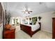 Serene main bedroom with a large bed, tray ceilings, and a cozy sitting area with plenty of natural light at 1133 Split Silk St, Valrico, FL 33594
