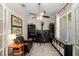 Inviting home office featuring french doors, a ceiling fan, built-in bookcases, and ample natural light at 1133 Split Silk St, Valrico, FL 33594