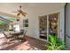 Outdoor patio area featuring a dining table, ceiling fan, and a view into the home at 1133 Split Silk St, Valrico, FL 33594