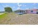 Backyard view of the waterfront access and enclosed patio at 1207 Norwich Cir, Sun City Center, FL 33573