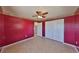 Spacious bedroom with closet, tiled floor, and decorative wallpaper accent border at 1207 Norwich Cir, Sun City Center, FL 33573