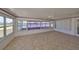 Bright Florida room with tiled floor and waterfront views from many large windows at 1207 Norwich Cir, Sun City Center, FL 33573