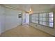 Enclosed Florida room featuring tile floor, large windows, and a doorway to the backyard at 1207 Norwich Cir, Sun City Center, FL 33573