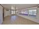 Bright Florida room with tiled floor, fan, and lots of natural light from large windows at 1207 Norwich Cir, Sun City Center, FL 33573