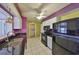 Kitchen features stainless appliances, granite counters, and ample cabinet space at 1207 Norwich Cir, Sun City Center, FL 33573