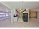Spacious kitchen featuring modern appliances, granite countertops, and access to laundry room at 1207 Norwich Cir, Sun City Center, FL 33573