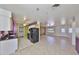 Bright kitchen opens to the living room and includes black appliances at 1207 Norwich Cir, Sun City Center, FL 33573